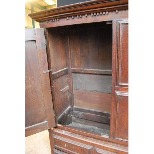 384 - Georgian oak hall cabinet, the projected moulded cornice over panelled doors over stepped base with ... 