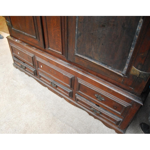 384 - Georgian oak hall cabinet, the projected moulded cornice over panelled doors over stepped base with ... 