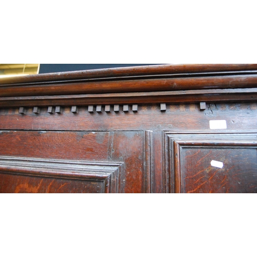 384 - Georgian oak hall cabinet, the projected moulded cornice over panelled doors over stepped base with ... 