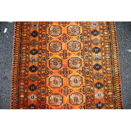 392 - Tekke rug with two rows of seven guls over orange ground, multiple borders, 106cm x 85cm.