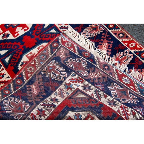 393 - Turkish rug with three cruciform octagonal panels, star and floral triple border, 120cm x 93cm.