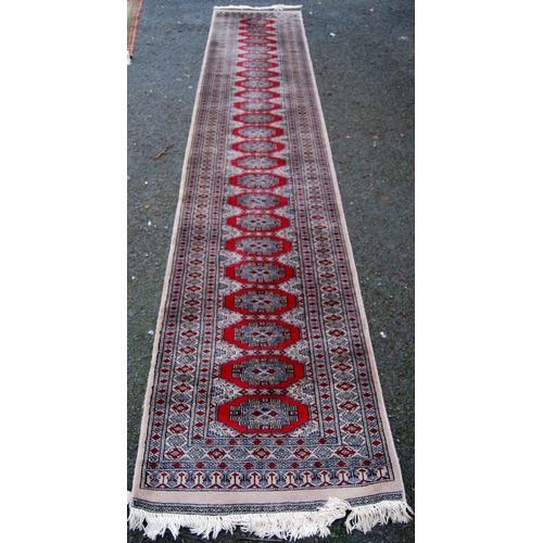 394 - Persian runner with single row of twenty-four guls over beige ground, triple border, 432cm x 81cm.