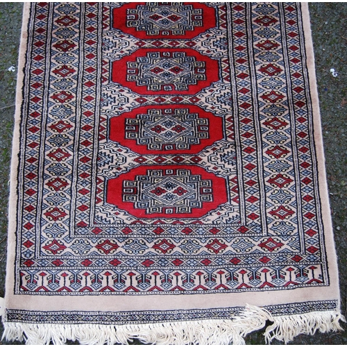 394 - Persian runner with single row of twenty-four guls over beige ground, triple border, 432cm x 81cm.