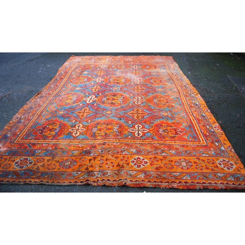 397 - Turkoman carpet with three rows of four medallions over blue ground, two rows of seven cruciforms, o... 