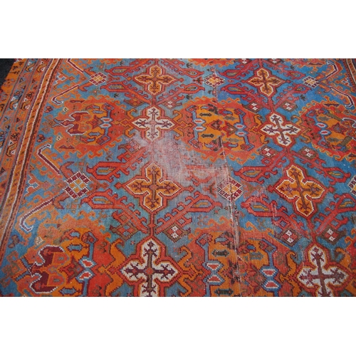 397 - Turkoman carpet with three rows of four medallions over blue ground, two rows of seven cruciforms, o... 