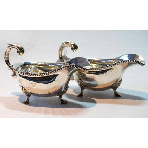 62 - Pair of sauce boats of Georgian style with gadrooned edges and flying scroll handles, London and She... 