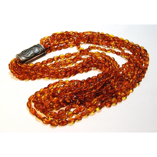 68 - Butterscotch amber necklace of seven strands on silver snap, gross 181g, snap approximately 60g.