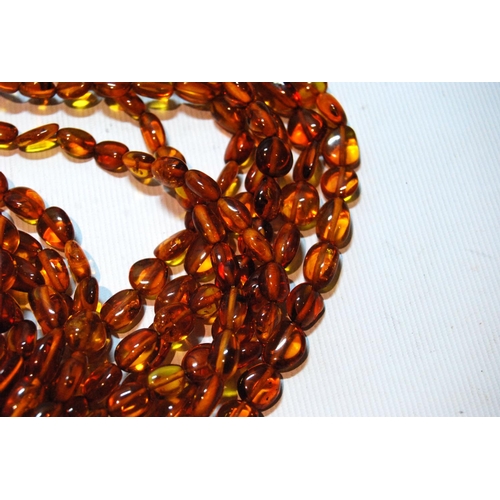 68 - Butterscotch amber necklace of seven strands on silver snap, gross 181g, snap approximately 60g.