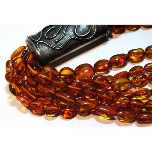 68 - Butterscotch amber necklace of seven strands on silver snap, gross 181g, snap approximately 60g.