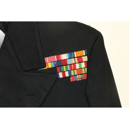 566 - British Royal Navy dress uniform jacket having Moss Bros & co Ltd of London label 