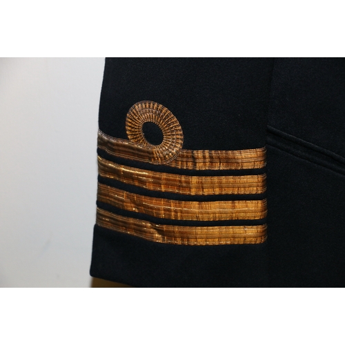 566 - British Royal Navy dress uniform jacket having Moss Bros & co Ltd of London label 