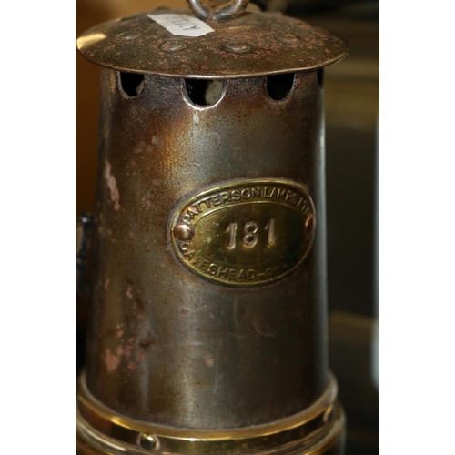 259 - Three miner's safety lamps including a Patterson Lamps Limited of Felling on Tyne type HCP miner's s... 