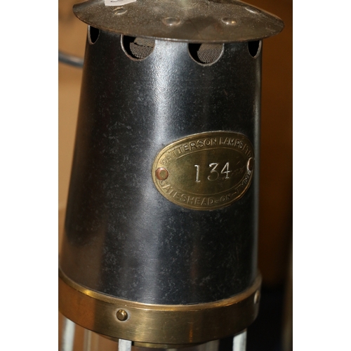 259 - Three miner's safety lamps including a Patterson Lamps Limited of Felling on Tyne type HCP miner's s... 