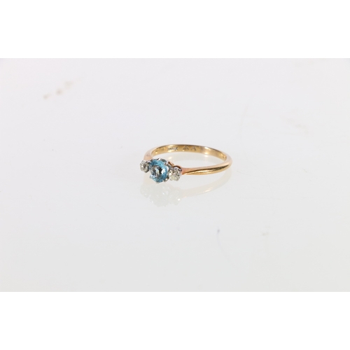 66 - 18ct gold and platinum three stone dress ring having central aquamarine flanked by two small diamond... 