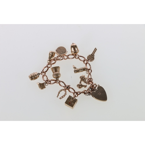 77 - 9ct gold curb link charm bracelet with padlock closure and eleven dependant 9ct gold charms includin... 