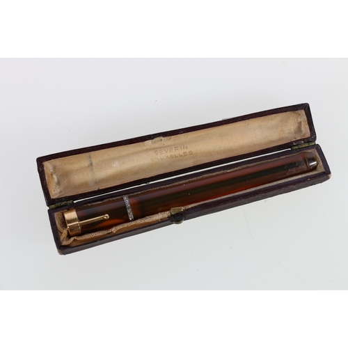 97 - Unhallmarked yellow metal mounted amber diamond set cheroot holder in fitted case marked Severin Bru... 