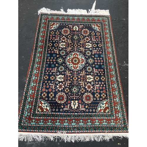 646 - Eastern blue ground fringed rug with Kishan Process Hamburg label, 210cm x 142cm