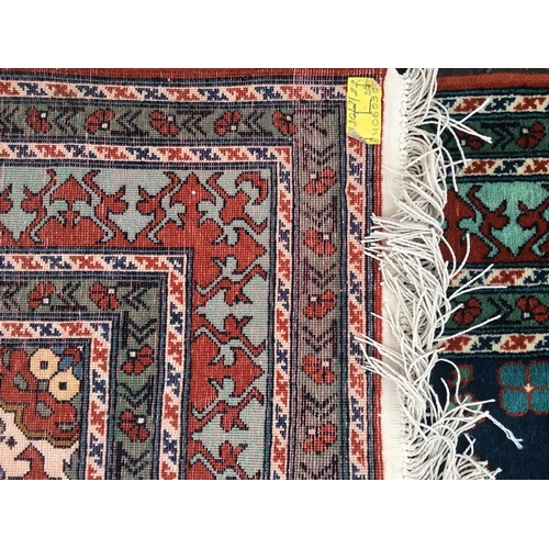 646 - Eastern blue ground fringed rug with Kishan Process Hamburg label, 210cm x 142cm