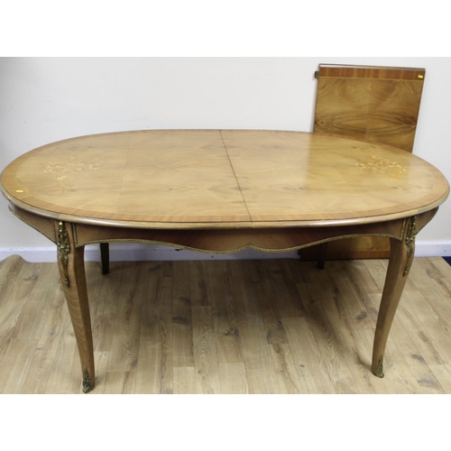 649 - Continental inlaid oval dining table with additional leaf, with gilt metal mounts, on scroll support... 