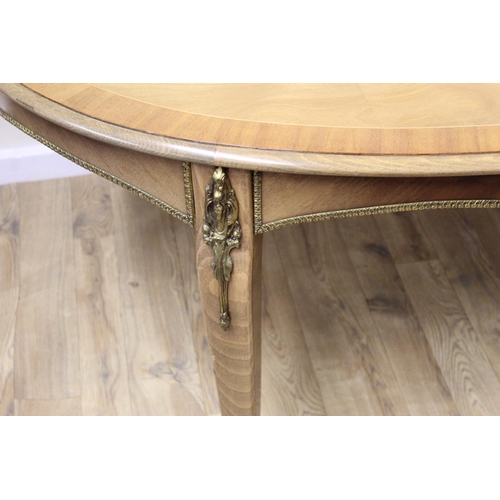 649 - Continental inlaid oval dining table with additional leaf, with gilt metal mounts, on scroll support... 