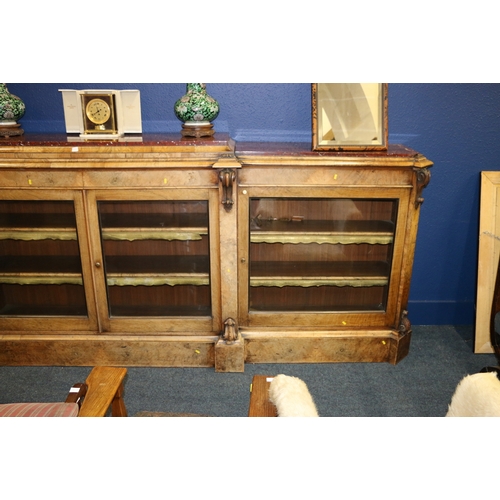 647 - Victorian Walnut breakfast library bookcase, the marble top raised on moulded plinth, over four glaz... 