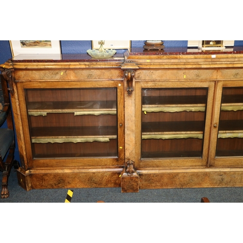 647 - Victorian Walnut breakfast library bookcase, the marble top raised on moulded plinth, over four glaz... 