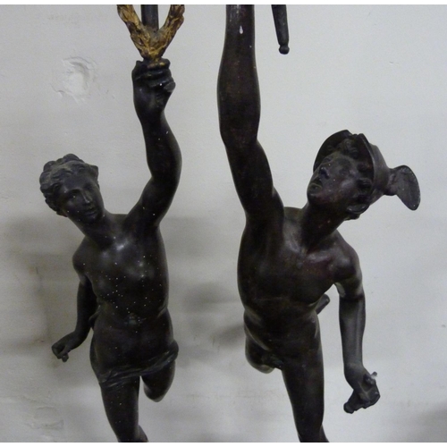 150 - Two large classical spelter figures, one holding a torch aloft