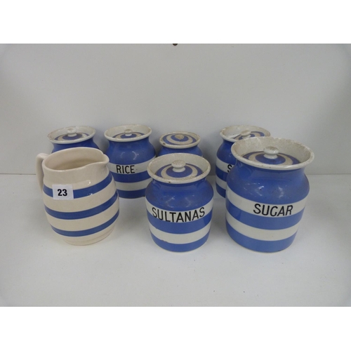 23 - Seven Cornish ware blue and white storage jars, some lids and a blue and white jug