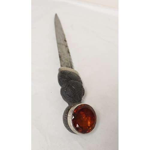 104 - Scottish piper's dirk with accompanying knife and fork. Carved ebony handles and citrine paste finia... 