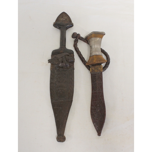 115 - Two antique Sudanese arm knives both of leaf form and with original leather scabbards. The smallest ... 