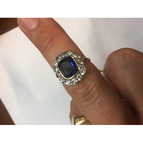 100C - 18ct gold sapphire blue stone and diamond ring, the blue stone approximately 10mm x 8mm encircled by... 