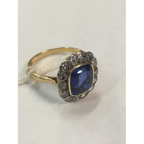 100C - 18ct gold sapphire blue stone and diamond ring, the blue stone approximately 10mm x 8mm encircled by... 