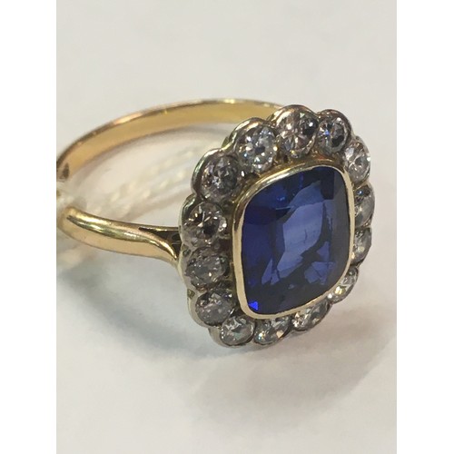 100C - 18ct gold sapphire blue stone and diamond ring, the blue stone approximately 10mm x 8mm encircled by... 