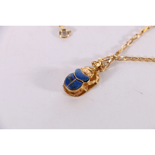 145 - Egyptian style yellow metal scarab beetle pendant set with blue lapis lazuli type stone (stamped 18 ... 