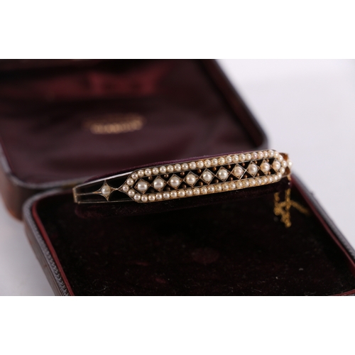 85 - Victorian unhallmarked yellow metal bangle set with seed pearls, 16.2g gross in Sorley of Glasgow fi... 