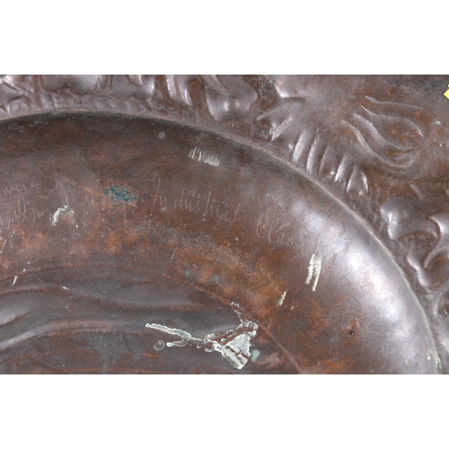 233 - An Arts & Crafts Newlyn School repousse copper charger decorated to the centre with galleon sail... 