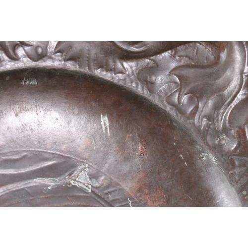 233 - An Arts & Crafts Newlyn School repousse copper charger decorated to the centre with galleon sail... 