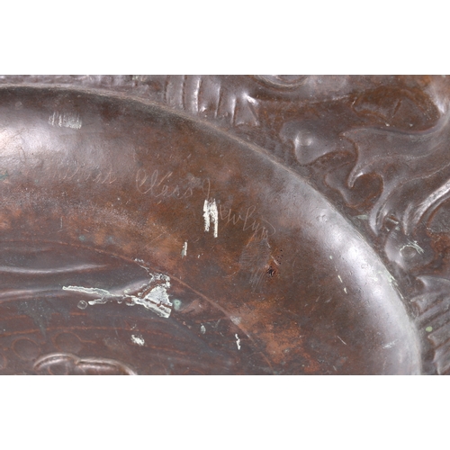 233 - An Arts & Crafts Newlyn School repousse copper charger decorated to the centre with galleon sail... 