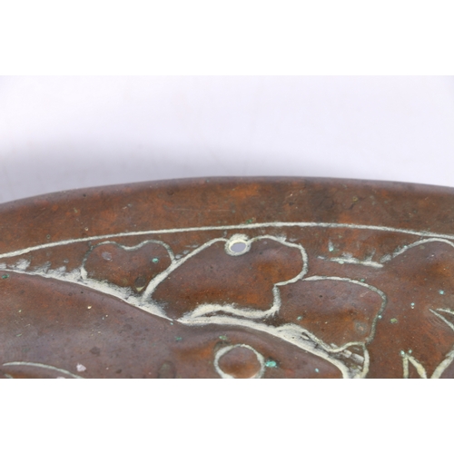 233 - An Arts & Crafts Newlyn School repousse copper charger decorated to the centre with galleon sail... 