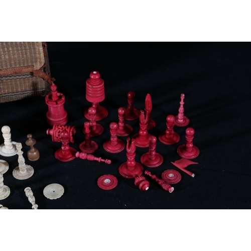 348 - Woven bag containing various white and red stained 19th century ivory chess pieces, (incomplete)