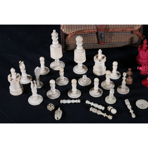 348 - Woven bag containing various white and red stained 19th century ivory chess pieces, (incomplete)