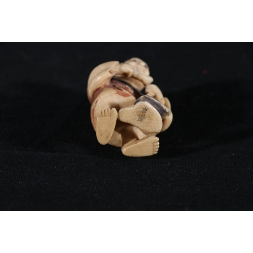 364 - A stained ivory netsuke of a farmer, holding a pipe, coloured detail to his robe, 47mm, 18g, Taisho.