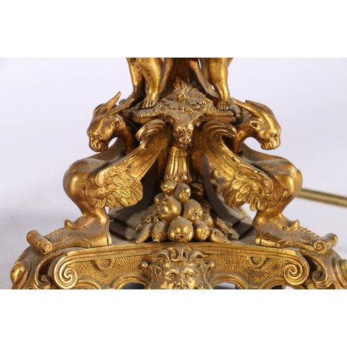 313 - Pair of gilded metal candlestick table lamps, the ornate stems supported by a trio of cherub musicia... 