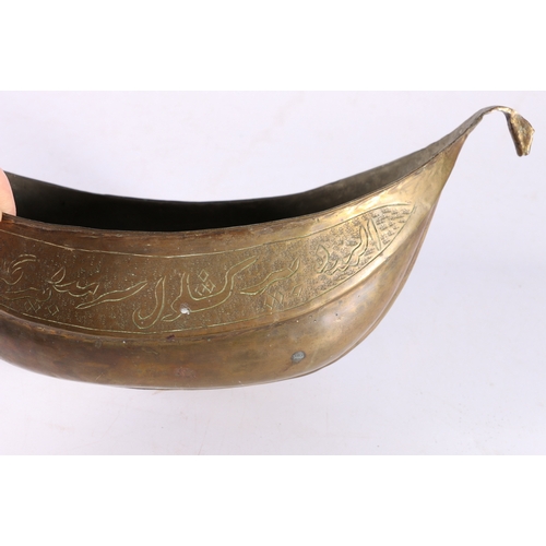 342 - A 19th century Indo Persian brass kashkul, the sides with calligraphic decoration, zoomorphic handle... 