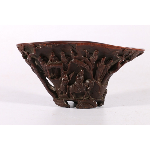 350 - 19th century Chinese carved rhinocerous horn libation cup carved to the exterior with figures on hor... 