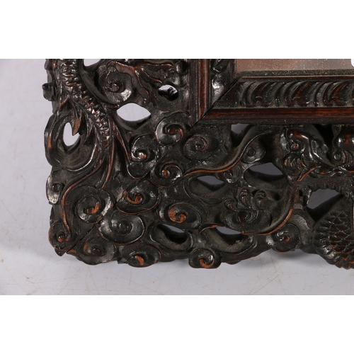 371 - Chinese late 19th century carved and pierced mirror frame, the frame depicting dragons amongst waves... 