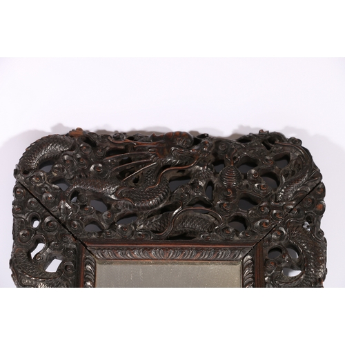 371 - Chinese late 19th century carved and pierced mirror frame, the frame depicting dragons amongst waves... 