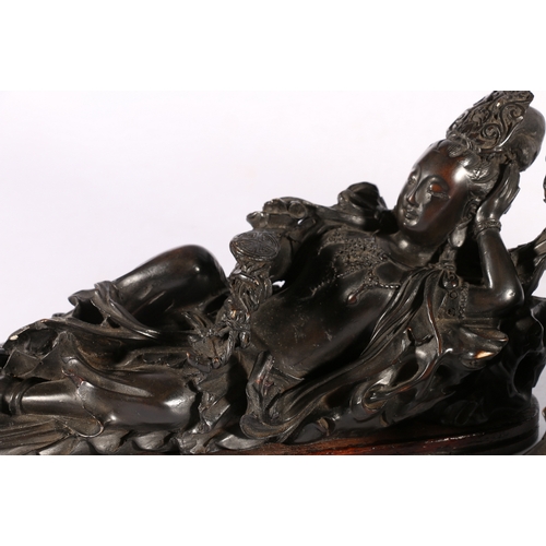 384 - A pair of early 20th century carved wooden figures depicting a lohan and Quan Yin holding a ruyi sce... 