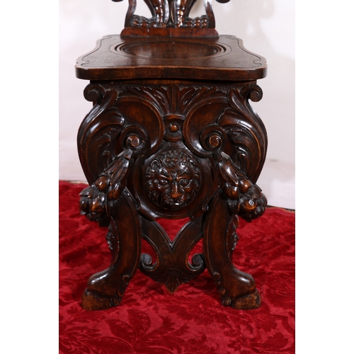 433 - Gothic revival heavily carved oak panel back hall chair raised on hoof supports with lion head to sk... 