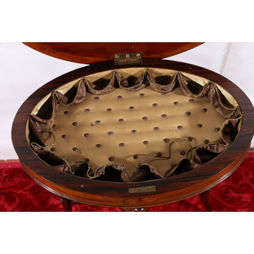 439 - Victorian rosewood and inlaid, oval hinged top work box, raised on shaped supports and brass castors... 